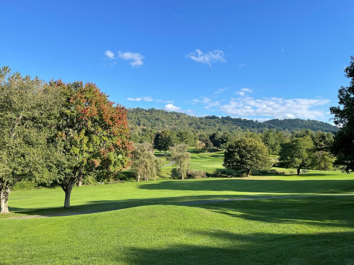 Early autumn color on a mountain golf fairway near Asheville under a clear blue sky