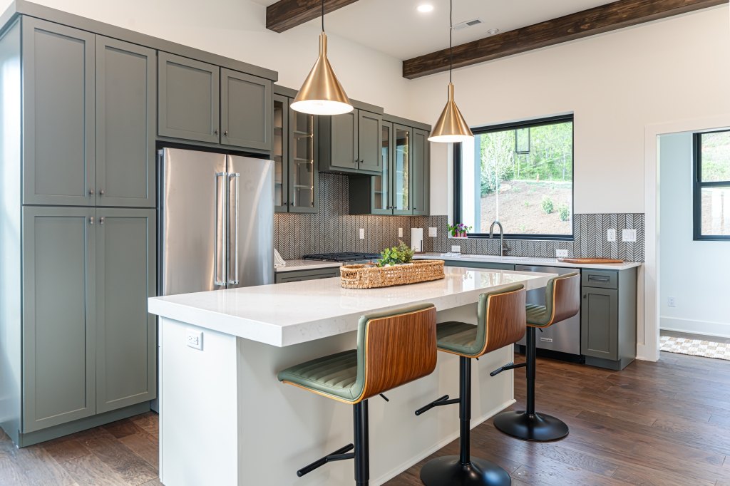 The Dogwood kitchen with island, brass pendants, and natural light