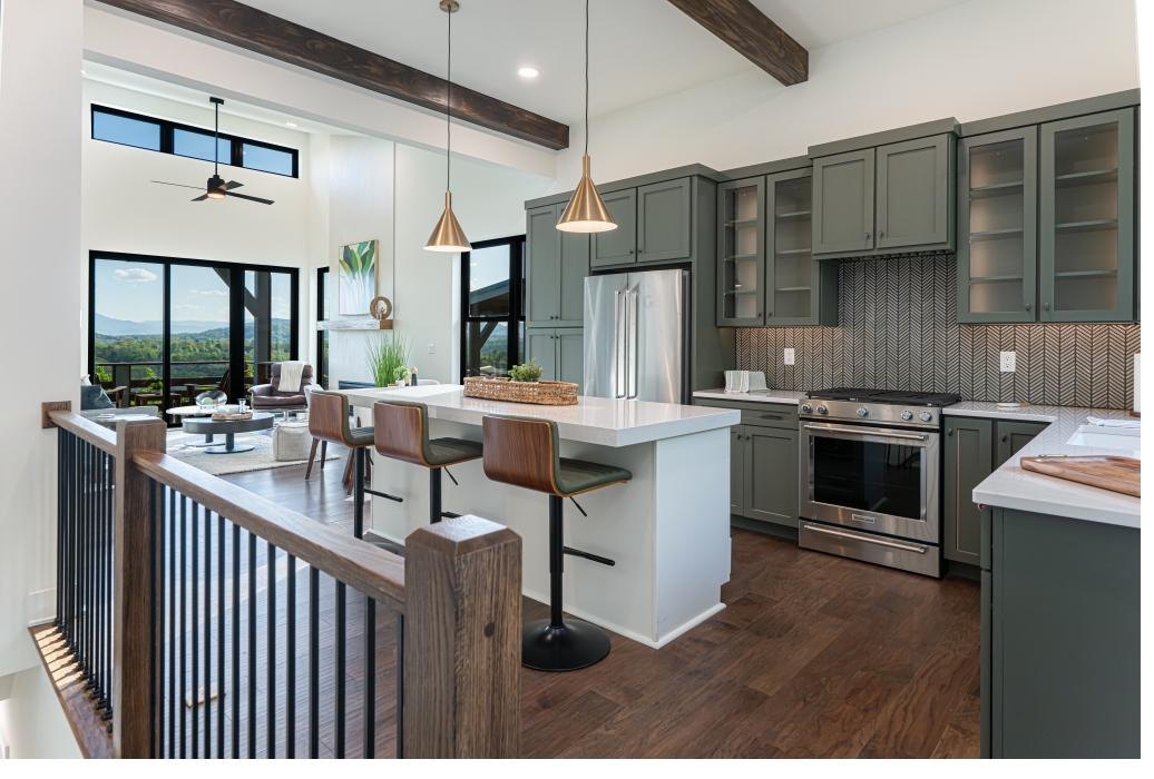 Chef's kitchen with quartz waterfall island and brass pendants