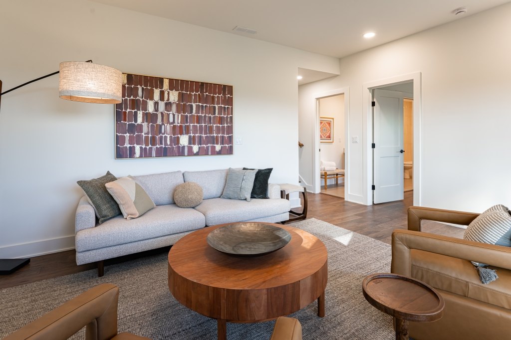 Lower-level living area with leather seating and natural light