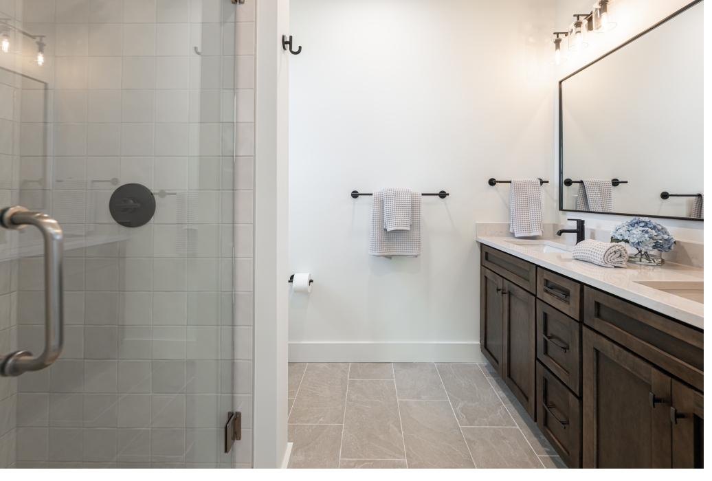 Spa-inspired primary bath with double vanity and walk-in shower